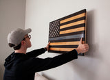 man hanging thin blue line flag