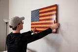 man hanging American Flag wall art